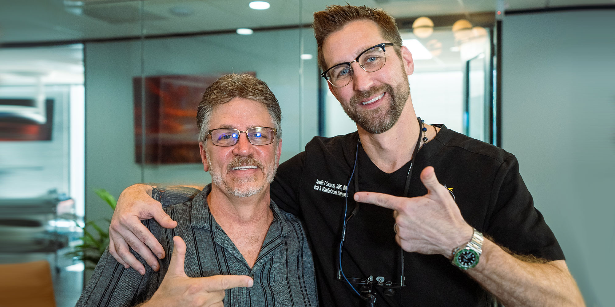 patient and Dr. Justin Seaman pointing at each other and smiling