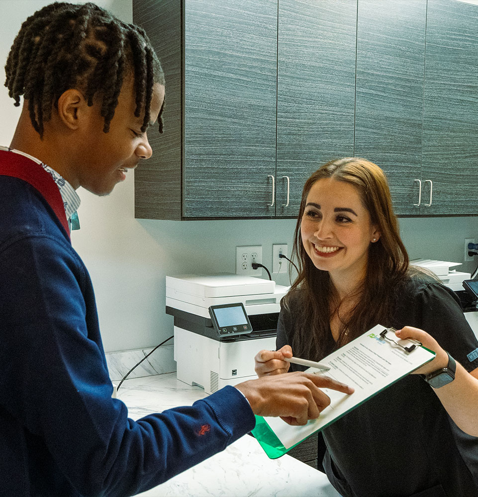 Staff member going over cost with patient