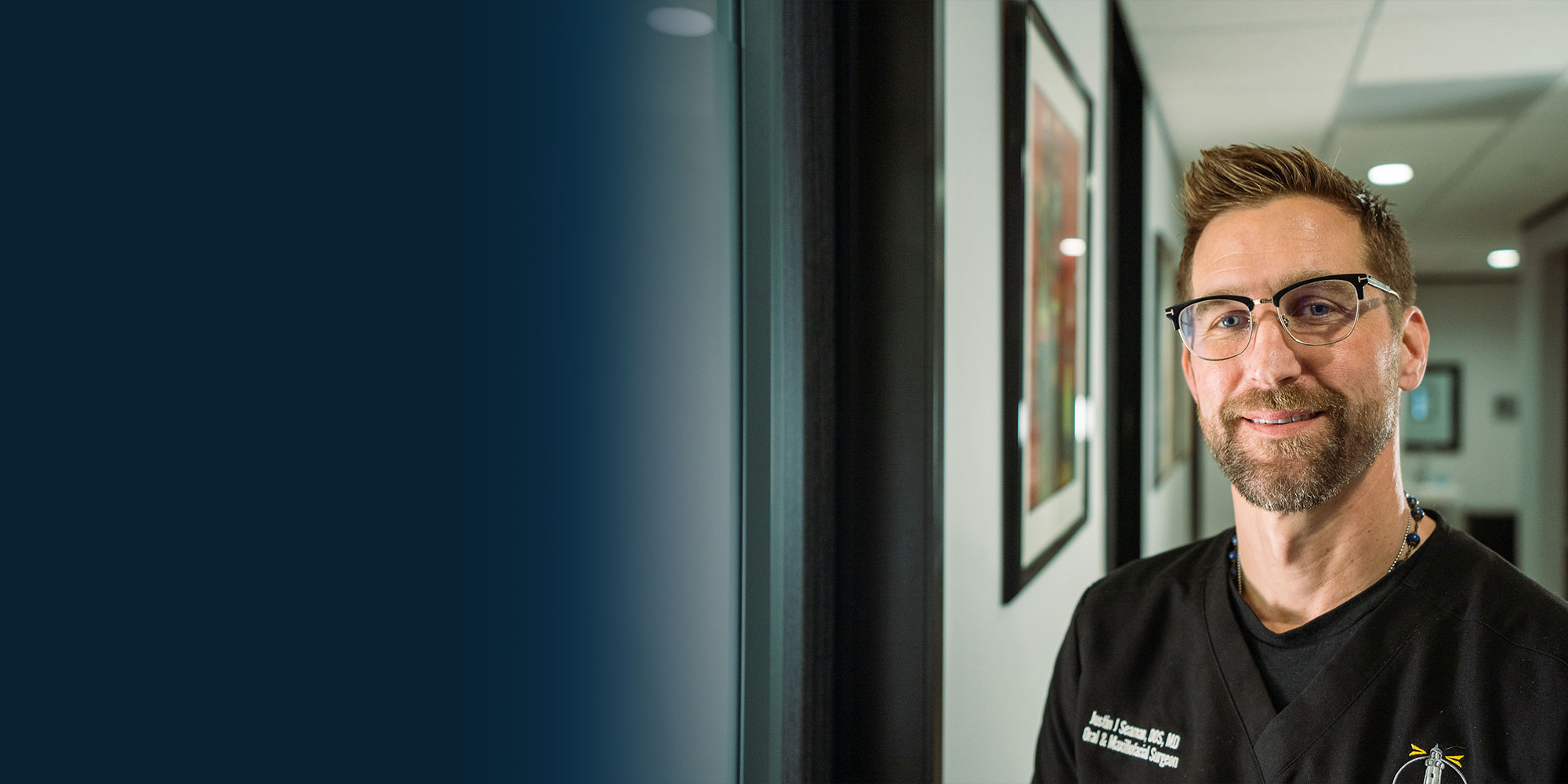 headshot of doctor smiling within the dental practice