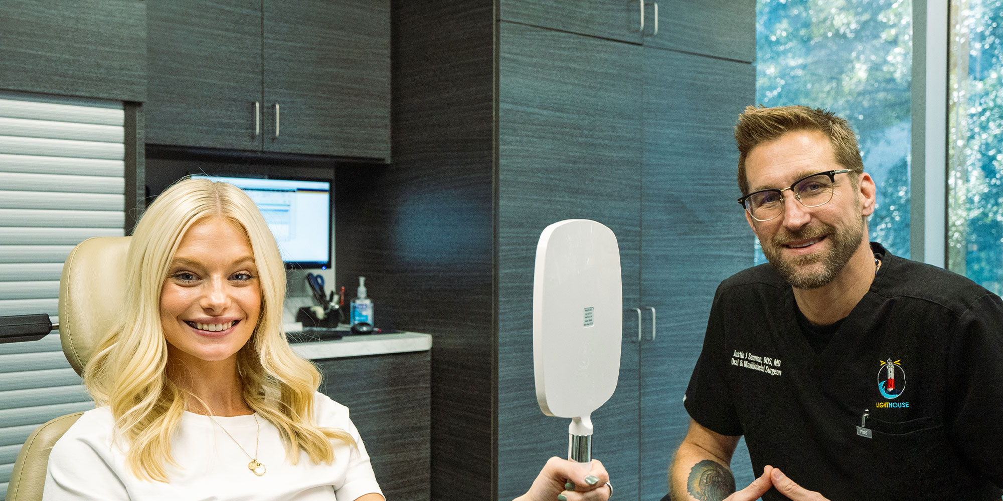 patient and doctor both smiling brightly after patients dental procedure